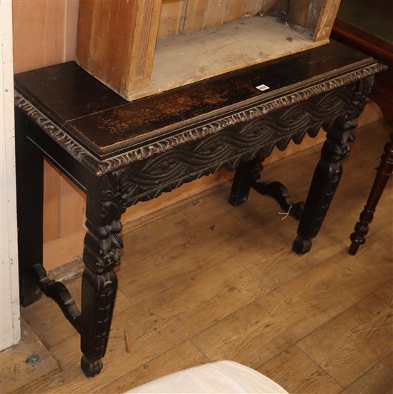 A carved oak side table W.104cm